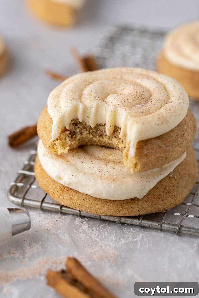 Delicious Crumbl Snickerdoodle Cupcake Cookies, frosted with cream cheese and dusted with cinnamon sugar.