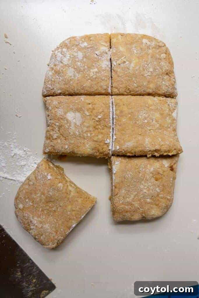 Pumpkin scone dough being shaped into a rectangle