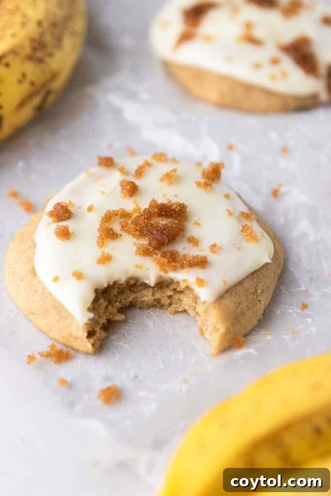 Crumbl banana bread cookies, perfectly glazed and topped with brown sugar crumbs.