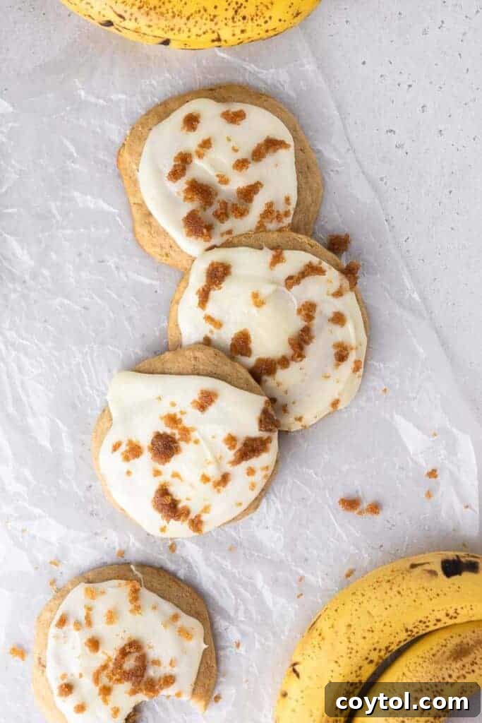 Another shot of glazed banana bread cookies on a white surface.