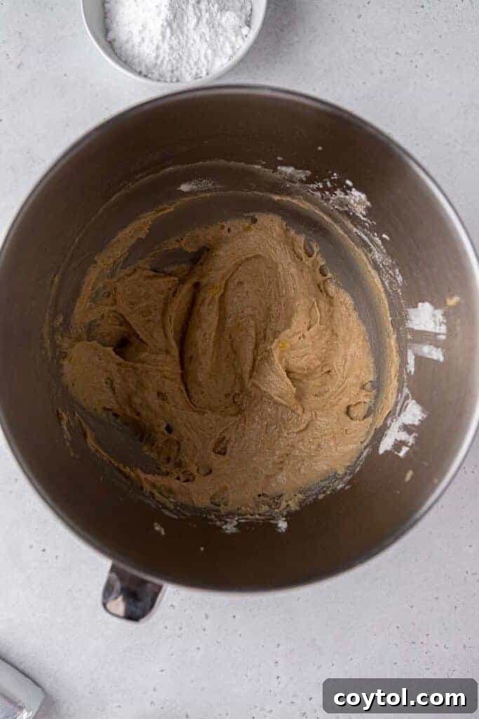 Banana bread cookie dough in a mixing bowl, ready for scooping and baking.