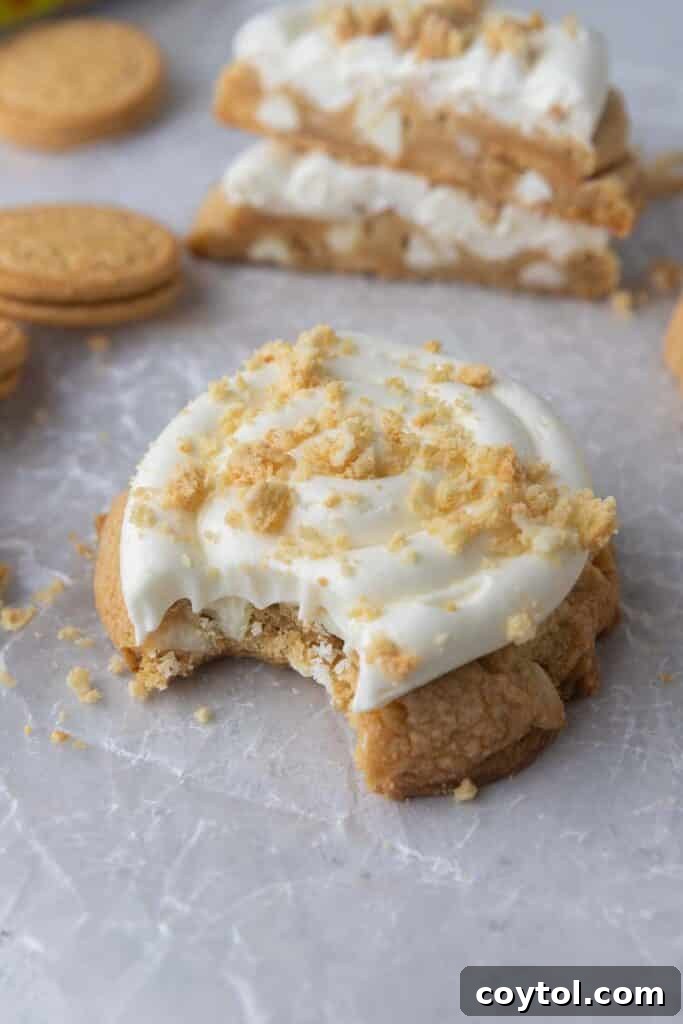 Frosted Golden Oreo cookie with a bite taken out, revealing its soft interior