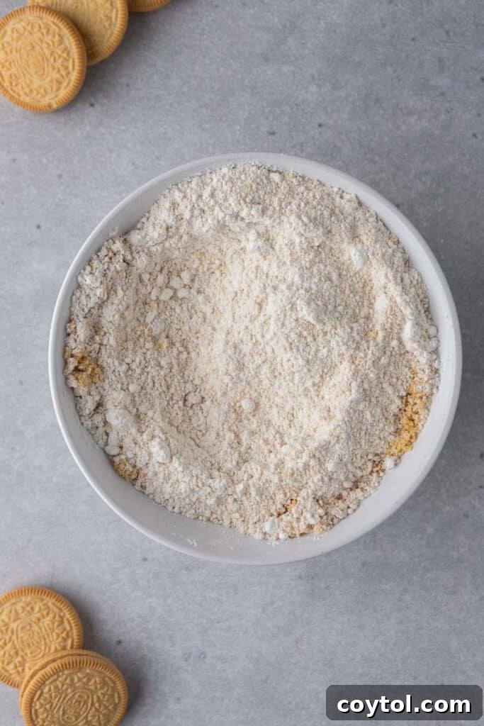 Dry ingredients mixed in a bowl, including crushed Golden Oreos, flour, and leavening agents