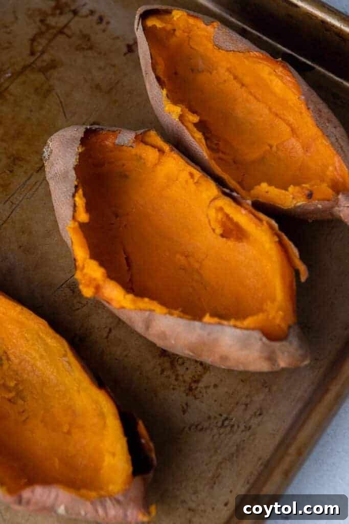 Twice-Baked Pecan Pie Sweet Potatoes 5 Sweet potatoes hollowed out after roasting showing smooth orange interior ready for filling