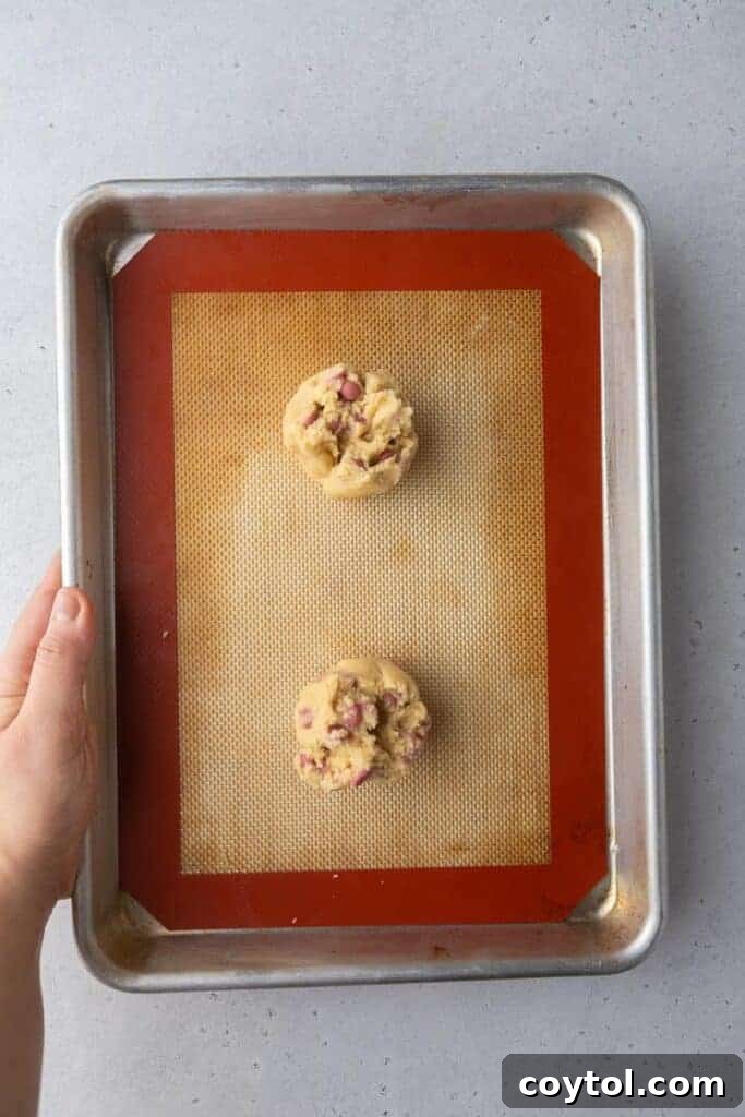 Cookies baking on a baking sheet in the oven