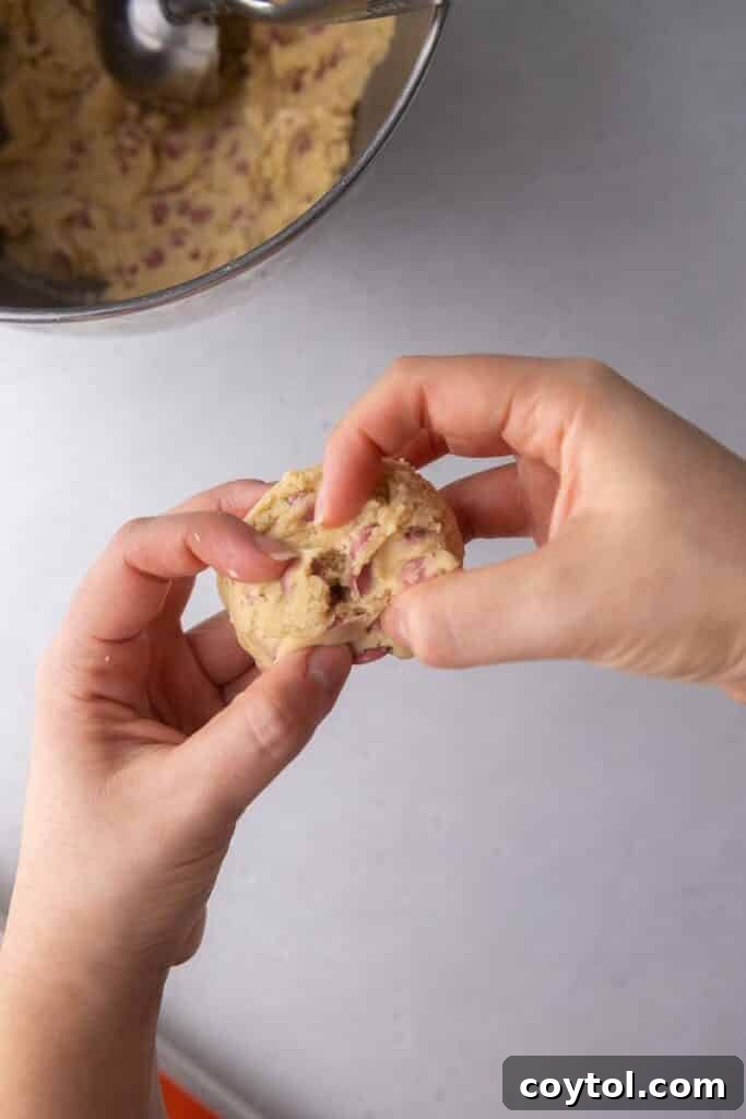 Cookie dough with ruby chocolate chips being split