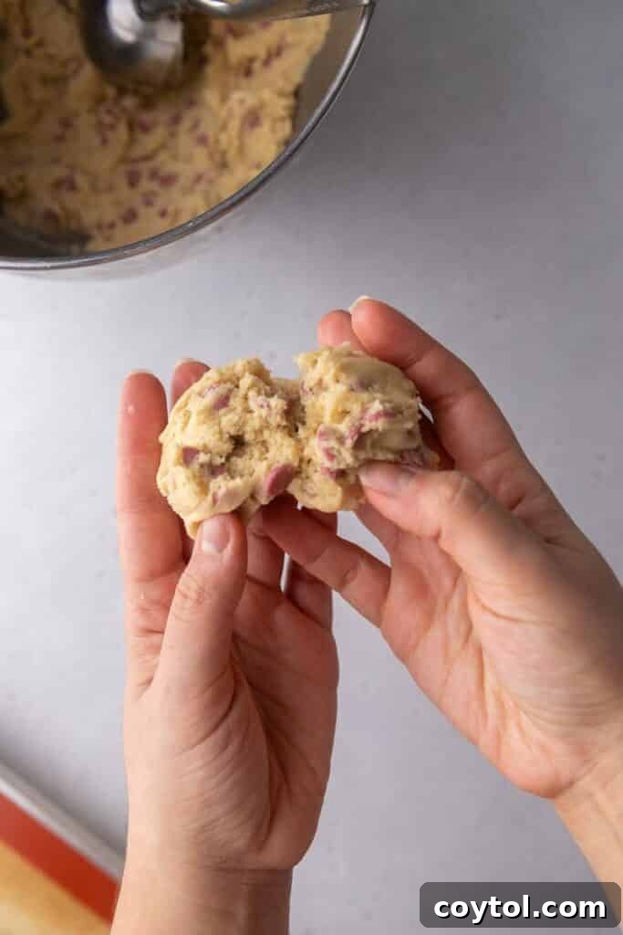 Two halves of cookie dough pressed together, jagged edges up