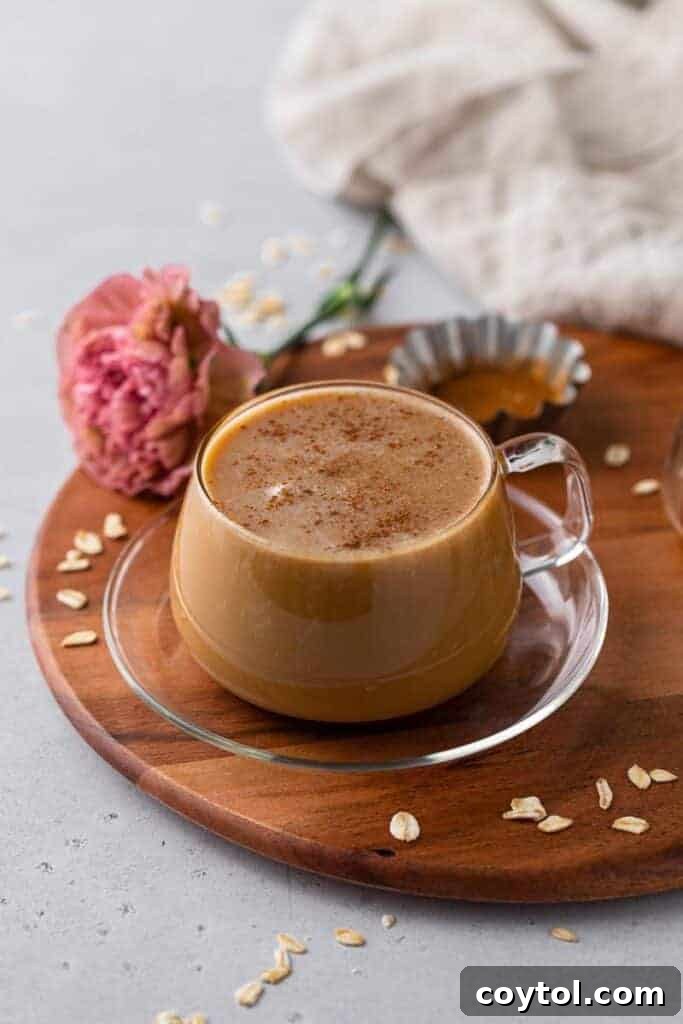 Golden Honey Oat Milk Latte: Hot or Iced 7 Cozy honey oat milk latte on a wooden tray with honey and oats, a Starbucks copycat coffee drink perfect for fall mornings.