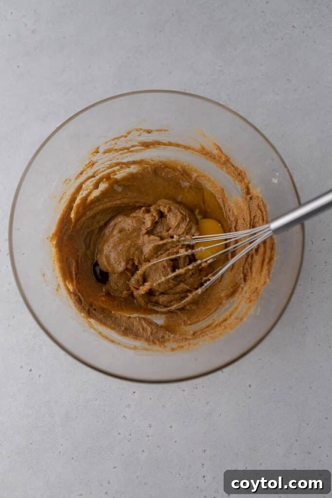 Creamed peanut butter, butter, and sugar in a mixing bowl, light and fluffy.