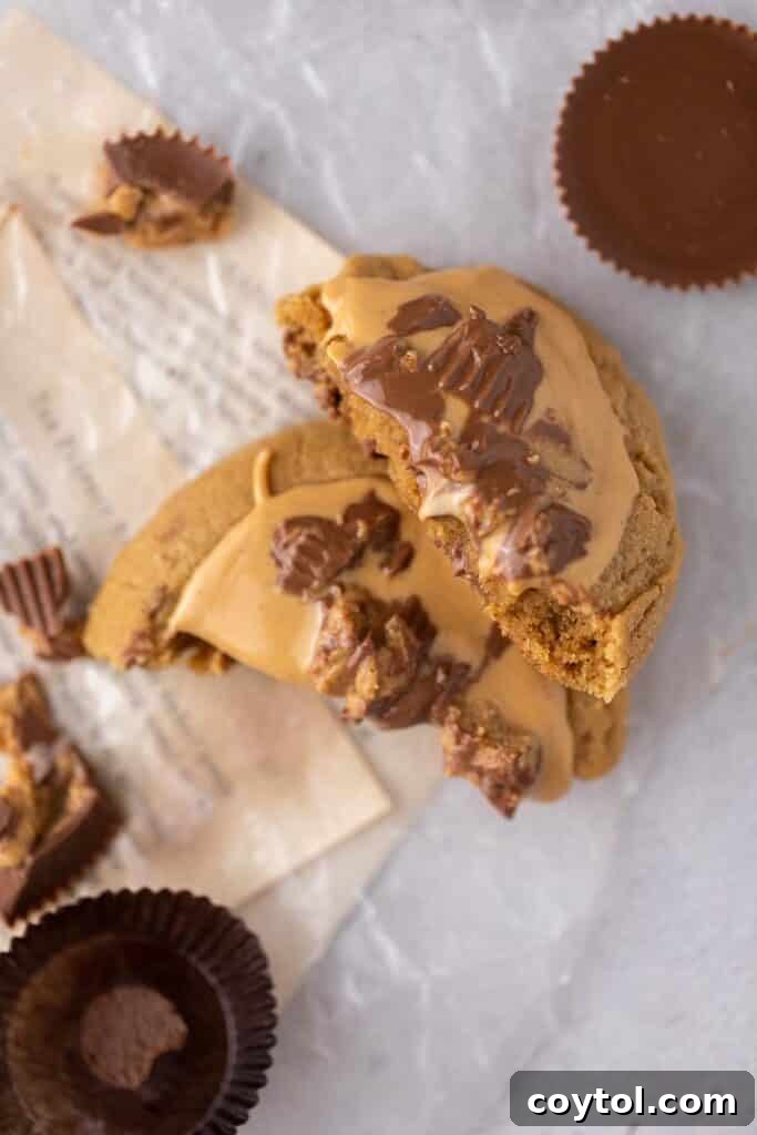 Crumbl Reese's peanut butter cup cookies broken in half, showing the chewy interior.