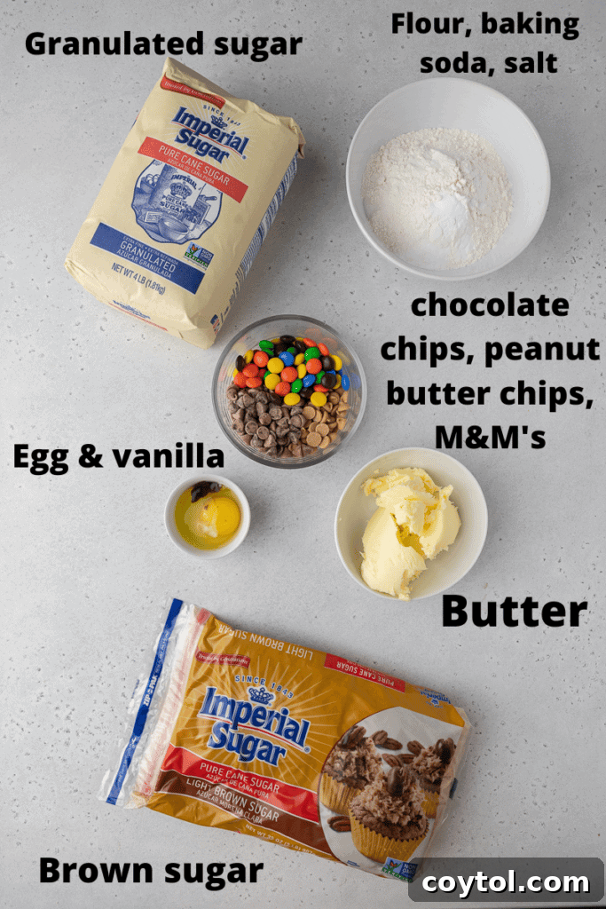 A colorful array of ingredients for Crumbl monster cookies, including M&M's, chocolate chips, peanut butter chips, butter, sugars, and flour.