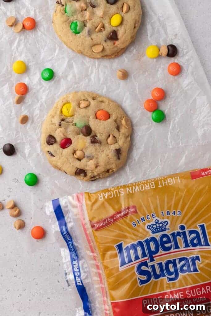 A bag of Imperial brown sugar rests beside a stack of delicious monster cookies, highlighting the quality ingredient.