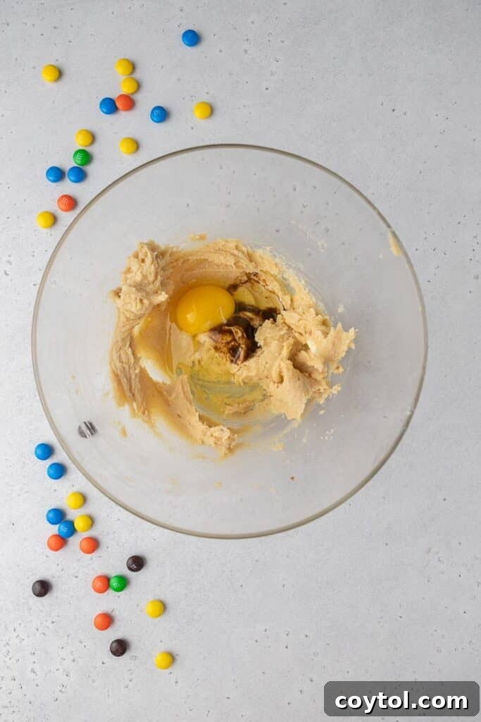 Butter and sugars being creamed together in a mixing bowl for monster cookie dough.