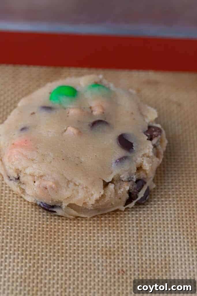 Another view of the monster cookie dough, perfectly spaced on a baking sheet, ready to go into the oven.