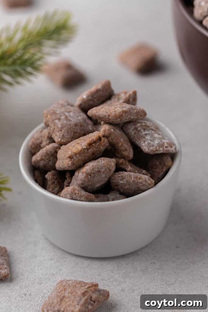 Small bowl of homemade muddy buddies with holiday vibes in the background