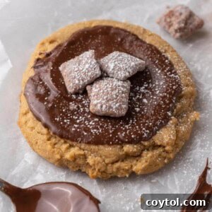 A perfectly baked Crumbl Muddy Buddies cookie, topped with chocolate and Chex pieces