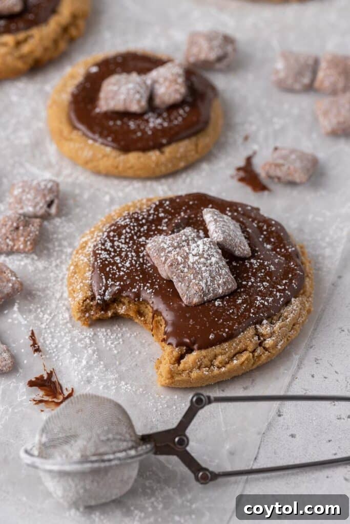 Delicious Crumbl peanut butter muddy buddy cookies with melted chocolate and cereal pieces