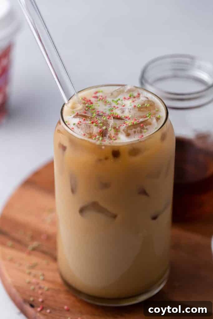 Homemade Starbucks Sugar Cookie Latte with Almond Milk 6 A beautifully assembled Starbucks Iced Sugar Cookie Almond Milk Latte in a glass, topped with sprinkles and ready to be enjoyed.