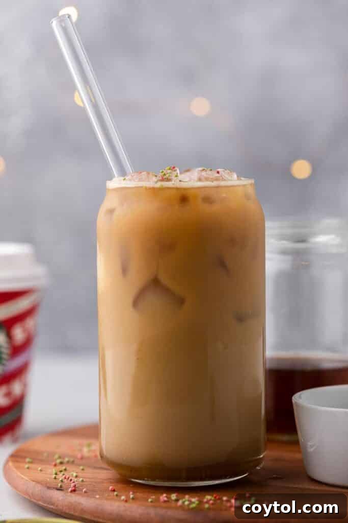 Homemade Starbucks Sugar Cookie Latte with Almond Milk 7 A Starbucks Sugar Cookie Latte served in a unique beer glass, adorned with festive sprinkles, highlighting its versatile and celebratory appeal.