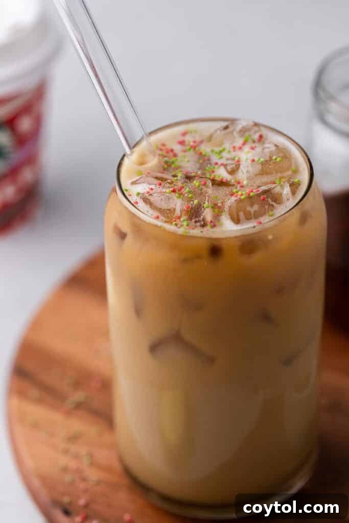 Homemade Starbucks Sugar Cookie Latte with Almond Milk 8 A beautifully presented Starbucks Sugar Cookie Almond Milk Latte, featuring a creamy texture and festive sprinkles, ready to be enjoyed.