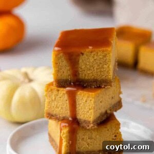 Stack of pumpkin cheesecake bars with caramel