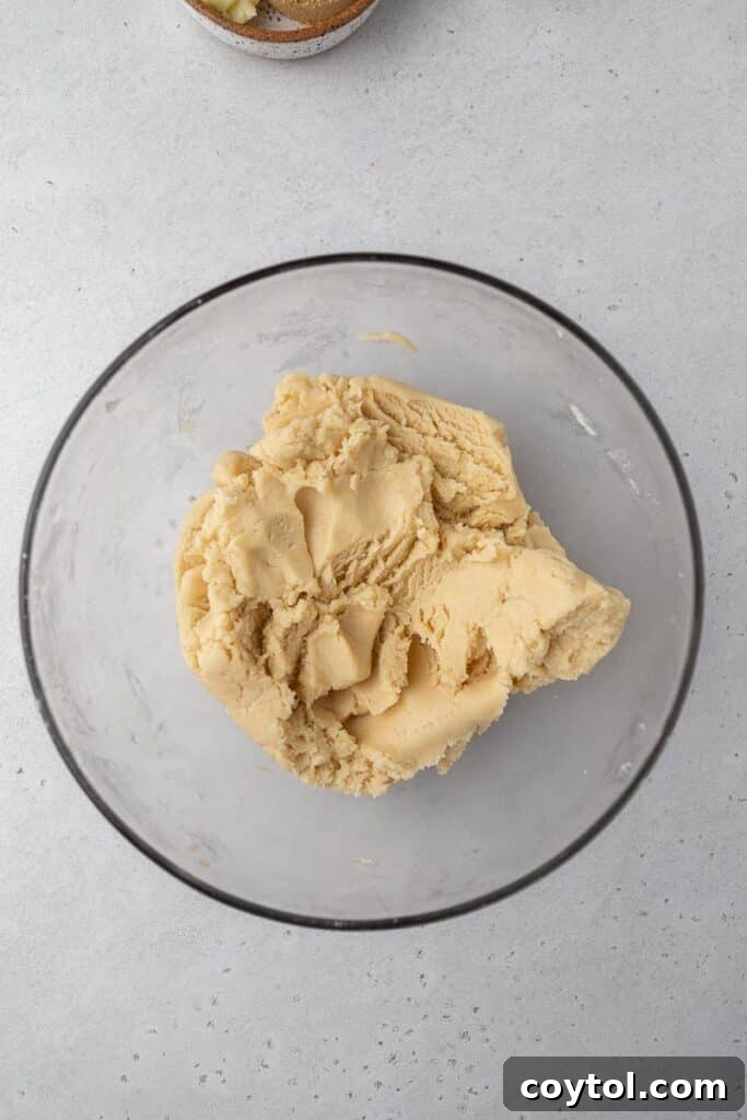 Bakery-Perfect Crumbl Pecan Pie Cookies Homemade 5 Smooth cookie dough in a glass bowl, perfectly mixed and ready for shaping.