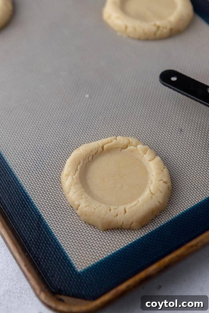 Bakery-Perfect Crumbl Pecan Pie Cookies Homemade 8 Cookie dough with perfect round indent ready for pecan filling, showcasing the prepared base.