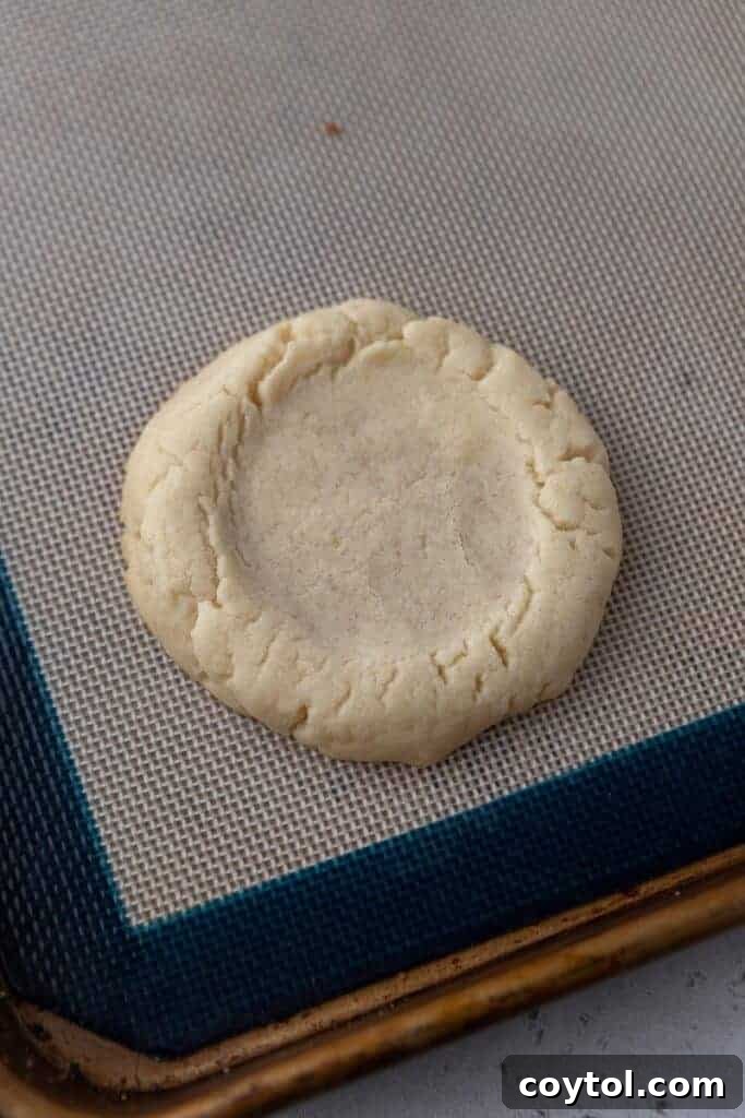Bakery-Perfect Crumbl Pecan Pie Cookies Homemade 9 Baked sugar cookie base with soft golden edges before topping with pecans, illustrating the perfect bake.