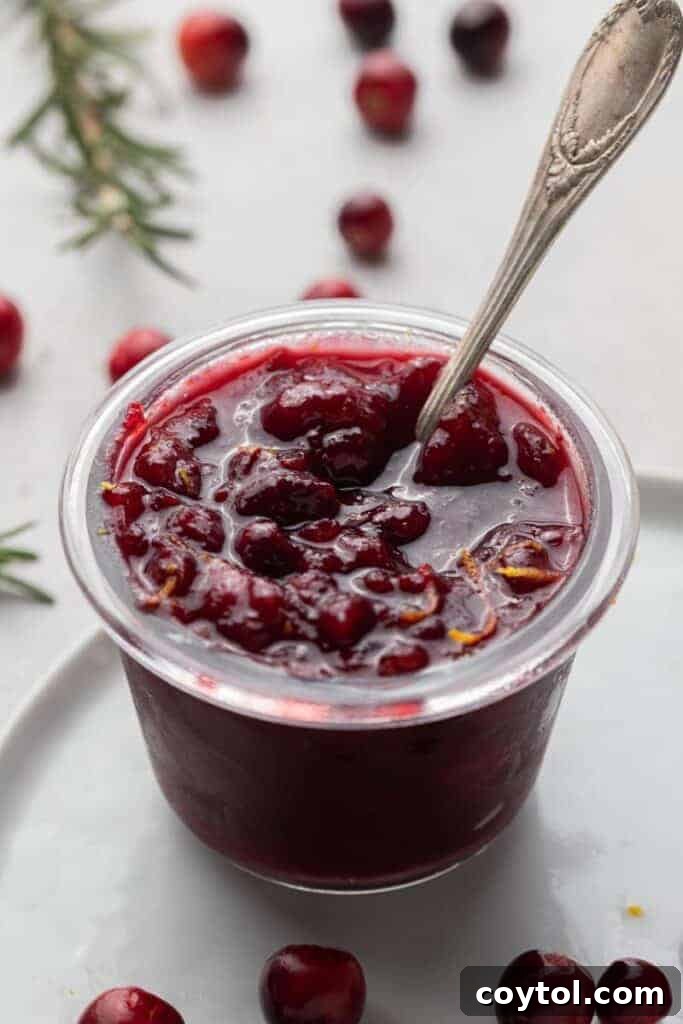 A jar of homemade orange cranberry sauce, ready for Thanksgiving dinner.