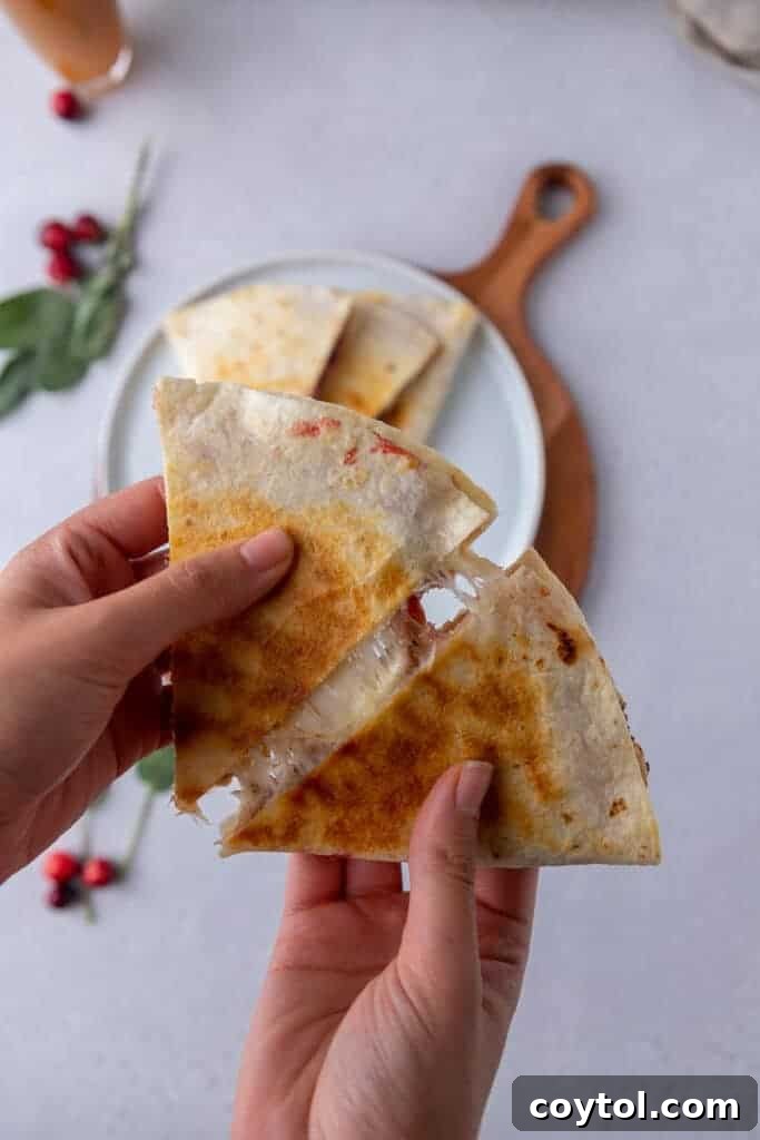 Thanksgiving leftover quesadillas cooking in a skillet, turning golden brown