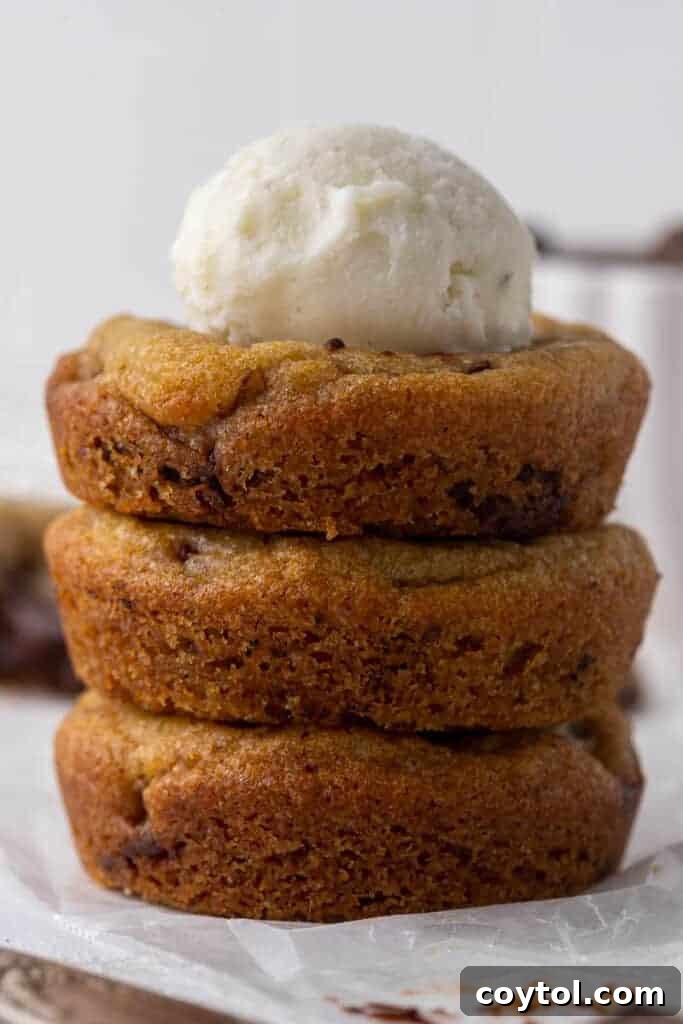 Delightful Mini Crumbl Chocolate Chip Cookie Cups 10 A close-up view of the interior of a warm, gooey chocolate chip cookie cup, highlighting the generous amount of melted semi-sweet chocolate chunks.