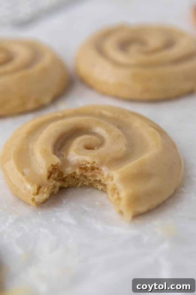 Crumbl Honey Bun Cookies: Sweet Perfection 15 Crumbl honey bun cookie with a bite taken out of it, showing soft texture.