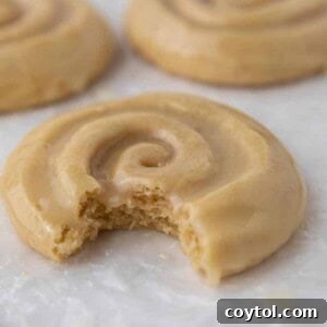 Crumbl Honey Bun Cookies: Sweet Perfection 14 Crumbl honey bun cookie with a bite taken out of it, showcasing its soft interior and glaze.