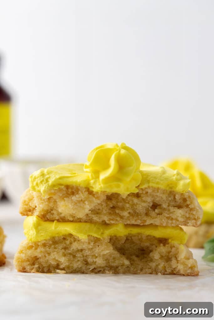 Frosted pineapple cookie cut in half revealing the soft interior