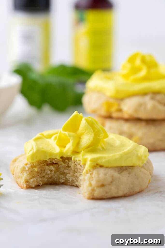 Crumbl Dole whip cookie with a bite taken out of it, showing soft interior