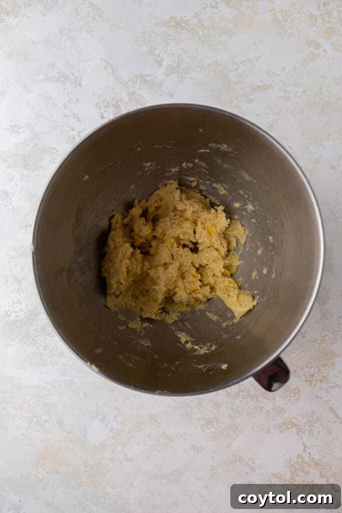 Pineapple cookie dough with crushed pineapple in mixing bowl