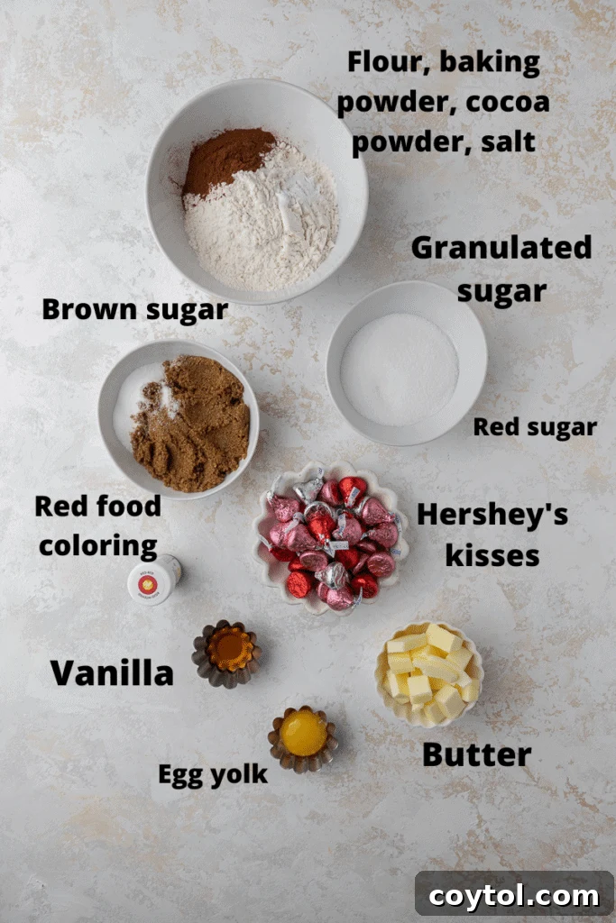 Display of red velvet blossom cookie ingredients, including butter, sugars, cocoa, flour, and Hershey's Kisses