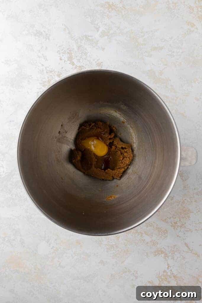 Creamed butter and sugar in mixing bowl, forming the base of the red velvet cookie dough
