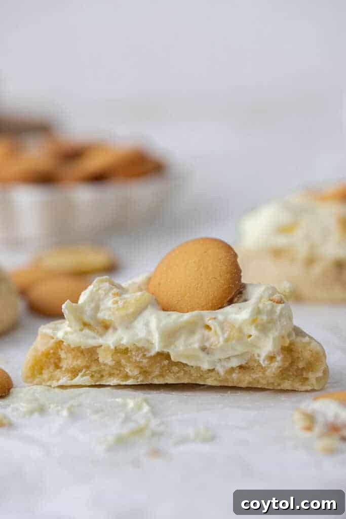 Crumbl's Sublime Chilled Banana Cream Pie Cookies 11 A Crumbl banana cream pie cookie cut in half, revealing the creamy banana pudding filling inside.