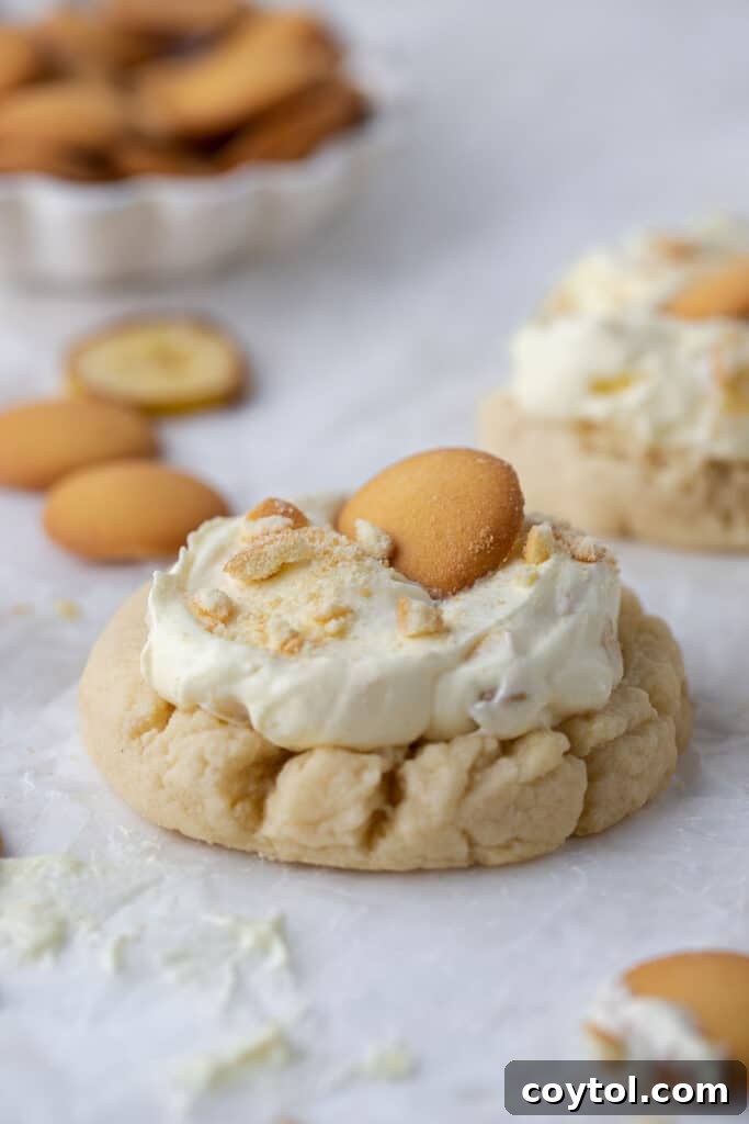 Crumbl's Sublime Chilled Banana Cream Pie Cookies 12 Straight-on shot of several Crumbl banana cream pie cookies, artfully arranged and ready to be enjoyed.