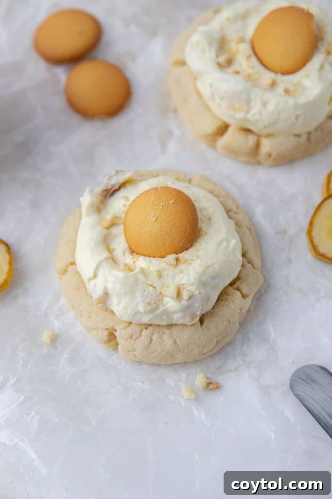 Crumbl's Sublime Chilled Banana Cream Pie Cookies 10 Finished Crumbl banana cream pie cookies arranged on a cooling rack, showcasing their topping.