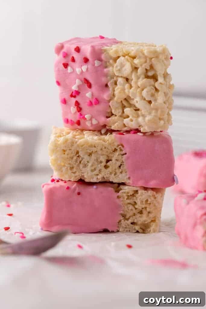 Stack of Valentine's day chocolate covered rice krispie treats, showing intricate sprinkle details.