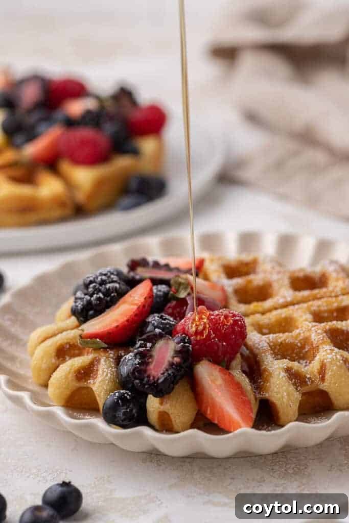 Maple syrup drizzled on top of waffles