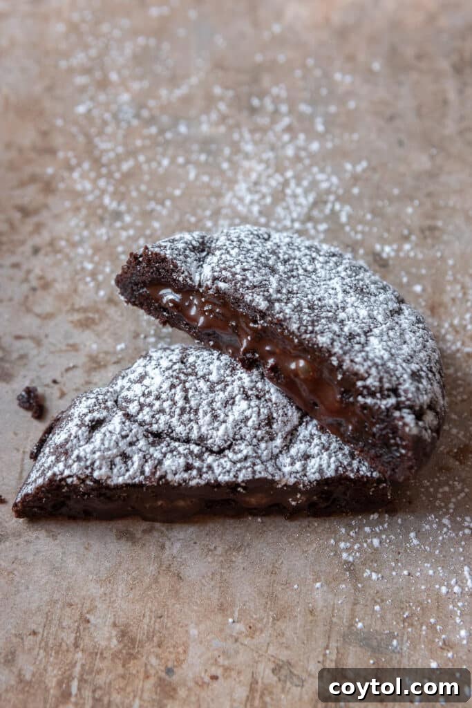 Molten lava cookie broken in half revealing its gooey center