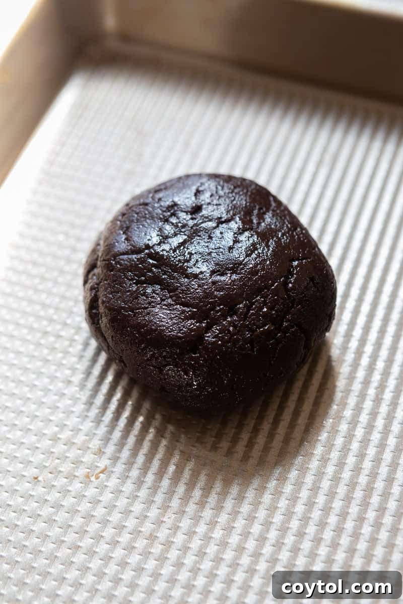 Chocolate cookie dough balls on a baking sheet