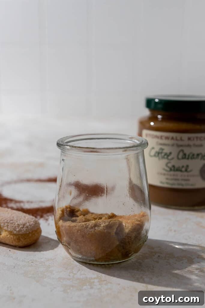 Lazy Caramel Macchiato Tiramisu Cups 7 Ladyfingers soaked in coffee in a serving cup, ready for layering