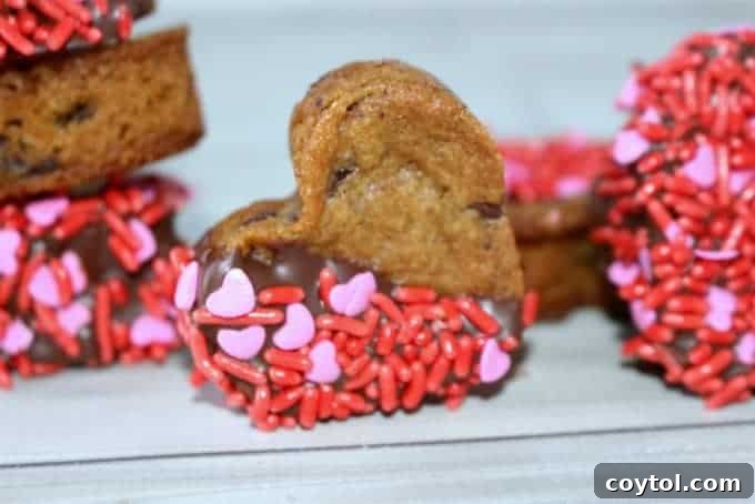18 Irresistible Valentine's Day Cookie Ideas 16 Heart-shaped chocolate chip cookies dipped in chocolate and adorned with Valentine's Day sprinkles.