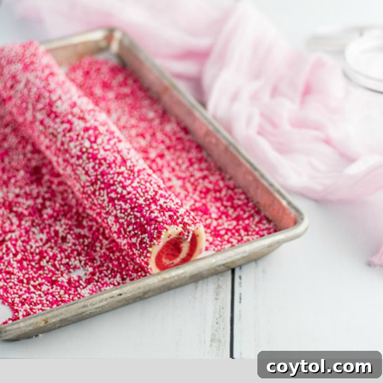 18 Irresistible Valentine's Day Cookie Ideas 24 Cookie dough completely covered in vibrant Valentine's Day sprinkles, ready to be baked into swirl cookies.