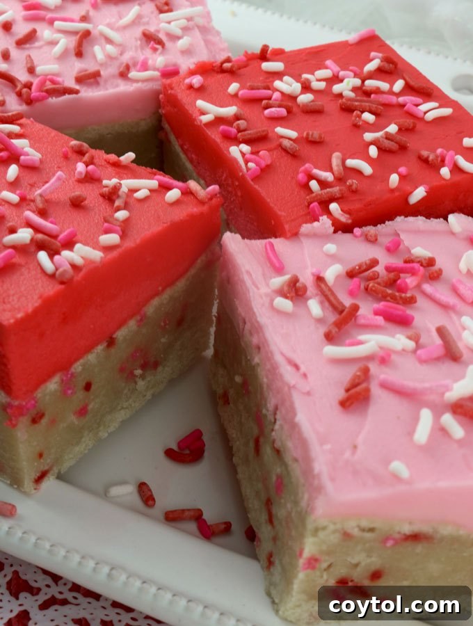18 Irresistible Valentine's Day Cookie Ideas 10 Festive sugar cookie bars topped with pink frosting, adorned with sprinkles, perfect for a Valentine's Day celebration.