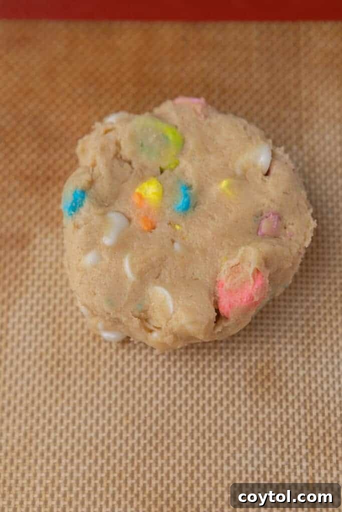 Crumbl lucky charms cookie dough in a baking sheet